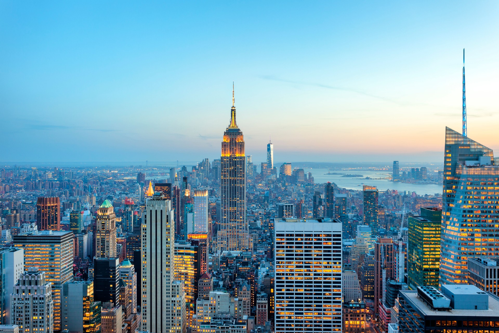 Manhattan panorama with its skyscrapers illuminated at dusk, New York